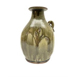 Jim Malone (British 1946-): Stoneware flask with trailing green glaze, incised floral decoration and lug handle, unmarked H20cm 