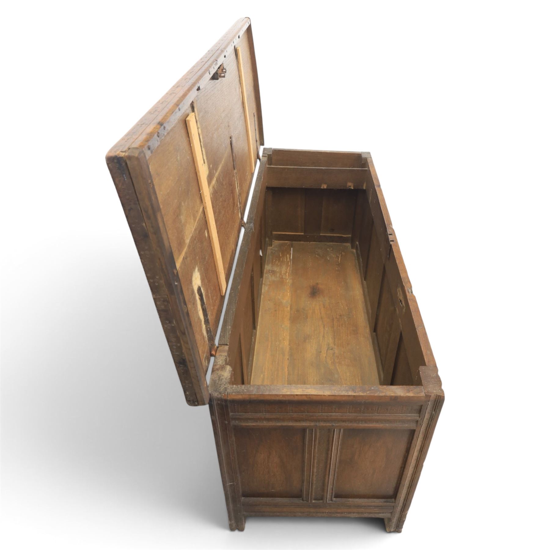 Large 17th century oak coffer, plank top with moulded edge, four panel front with channel moulded uprights, retaining original wrought iron strap hinges and central lock plate, panelled ends, raised on stile supports