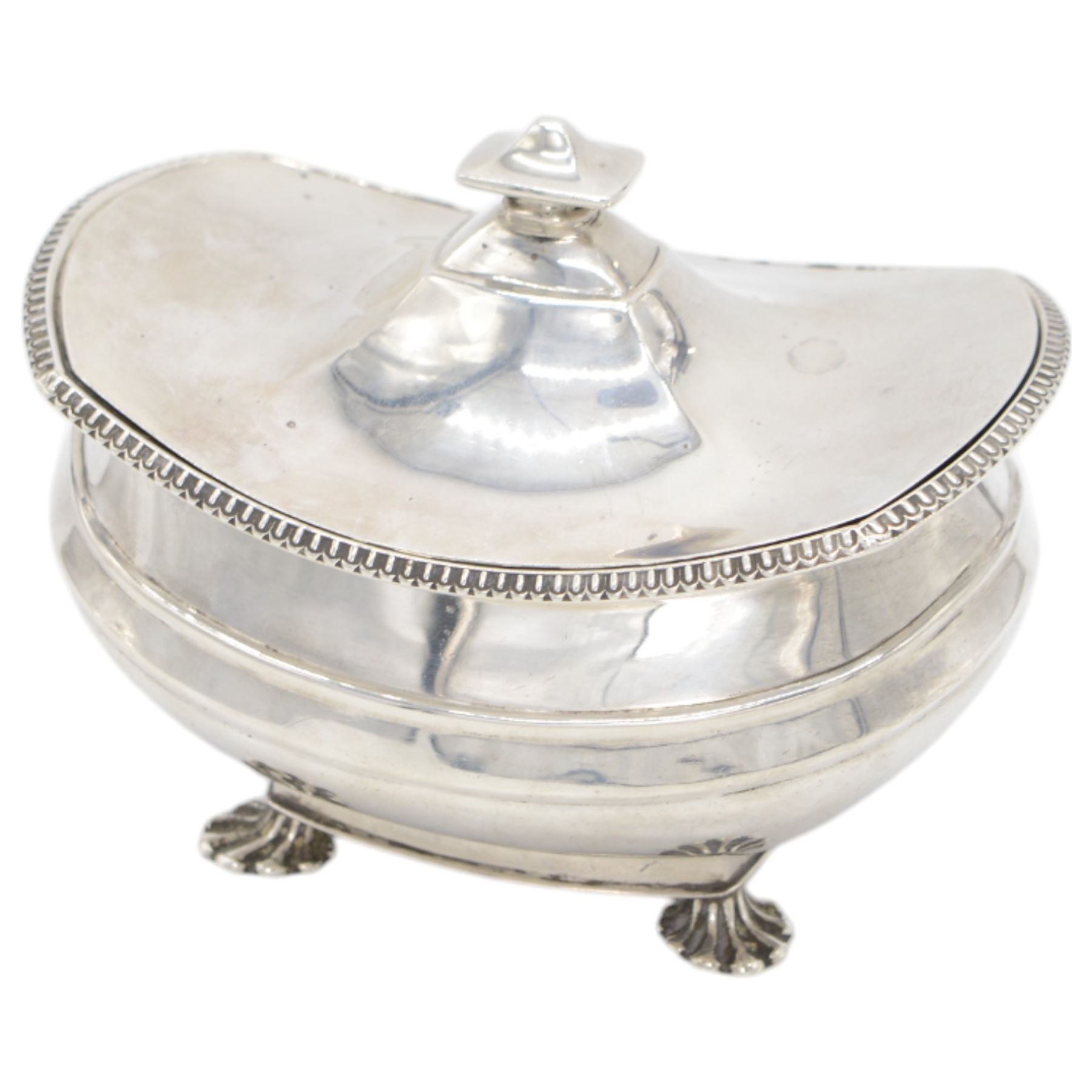 1920s silver sucrier and cover, of oval form with oblique gadrooned rim, the cover with rectangular finial, upon four splayed feet, H10.5cm