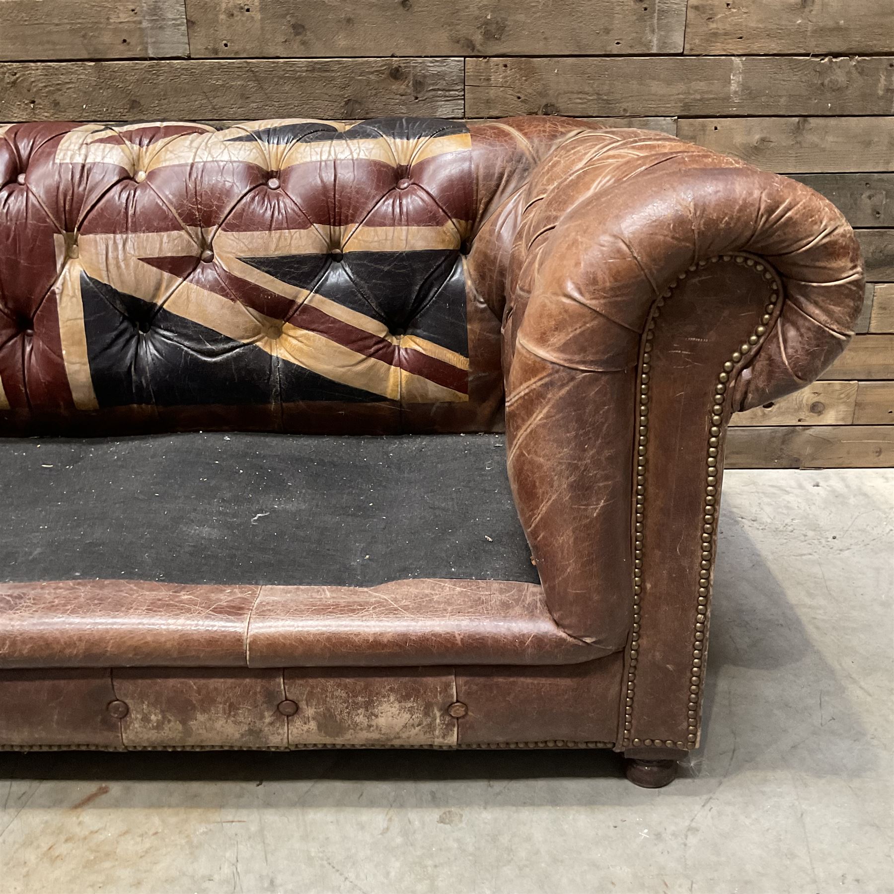 Chesterfield two sofa upholstered in brown leather, with Union Jack pattern, no seat cushions - located in storage, viewing not available