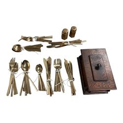  Bronze cutlery including fish knives, forks, salt and pepper, table spoons, forks etc and a wooden tea caddy