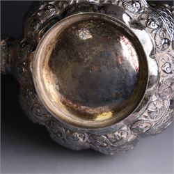 Three piece Indian silver tea service, comprising teapot, twin handled open sucrier and cream jug, each with embossed animal decoration with fish border, serpent handles and elephant finial, teapot H17cm