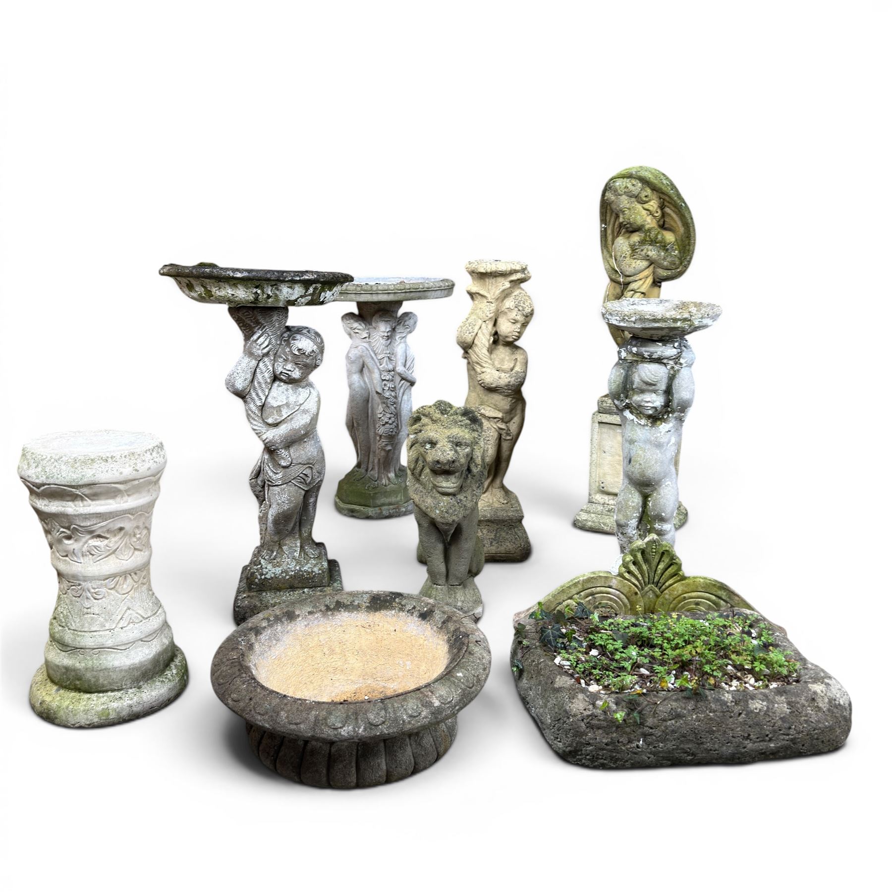 Collection of cast stone garden ornaments - three figure bird baths, figure on plinth, seated lion, lion, boy figure, and stone trough (9)