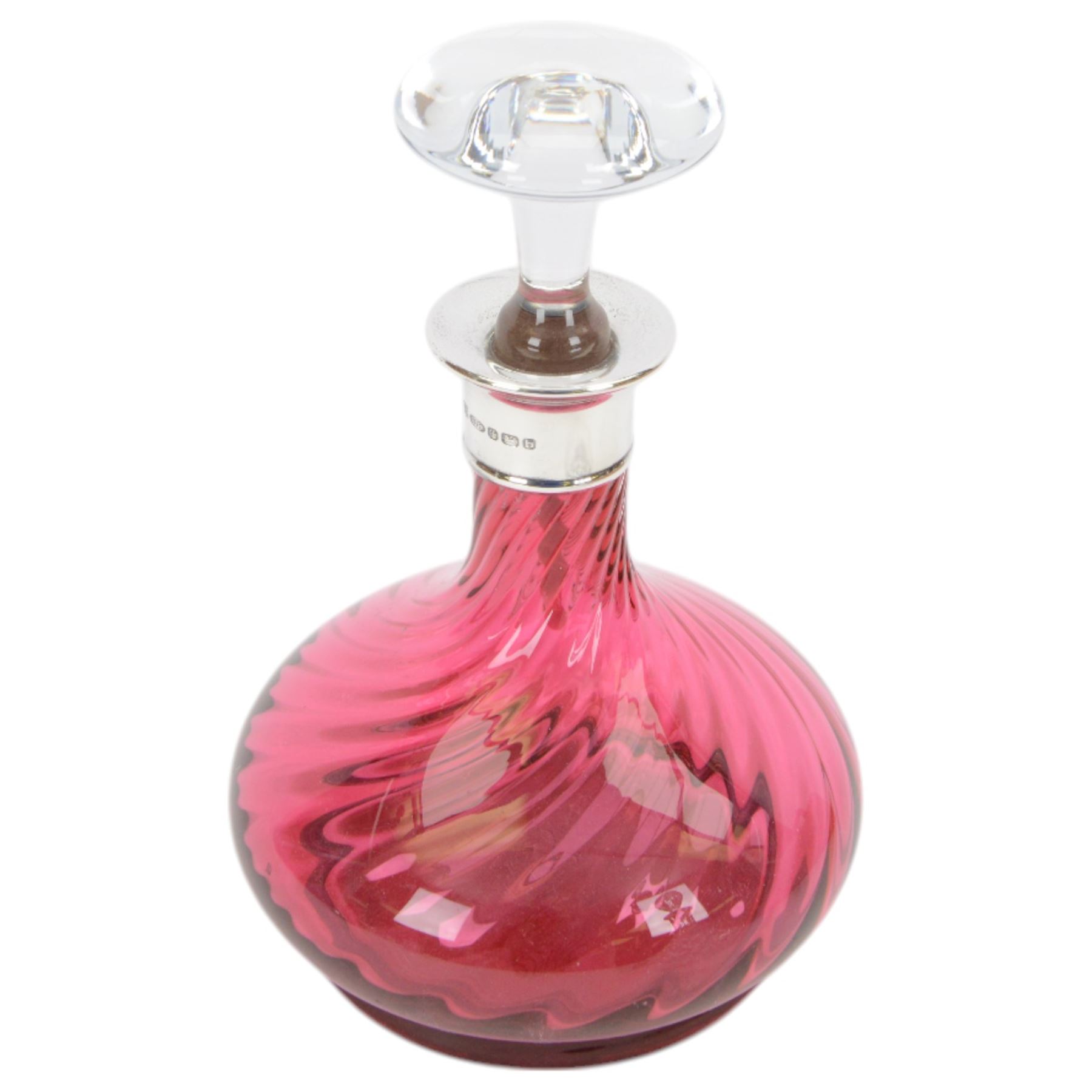 Two modern silver mounted glass decanters, the first a cranberry glass example, with fluted body, clear stopper and silver collar, hallmarked Barker Brothers Silver Ltd, Birmingham 2001, together with a clear cut glass example with silver collar, with import marks for London 1985, tallest H25.5cm