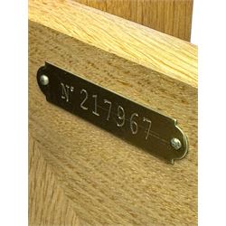 Contemporary light oak sideboard, chamfered rectangular top over two central bevel-edged drawers, flanked by two recessed panelled cupboards enclosing shelving, on square stile supports