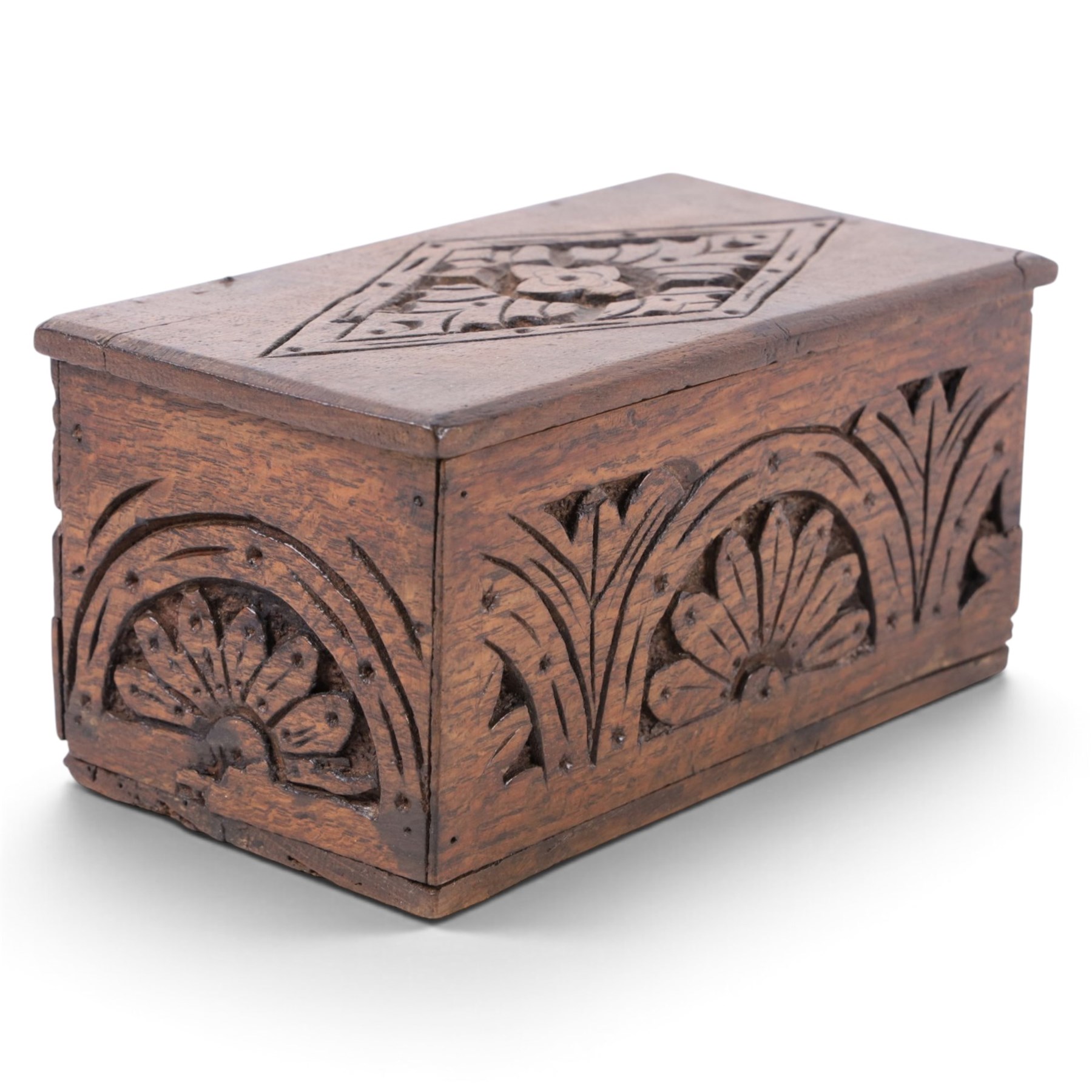 Carved oak box, the hinged lid with a carved diamond motif, the sides and front carved with stylised flowers, H12cm, L24cm