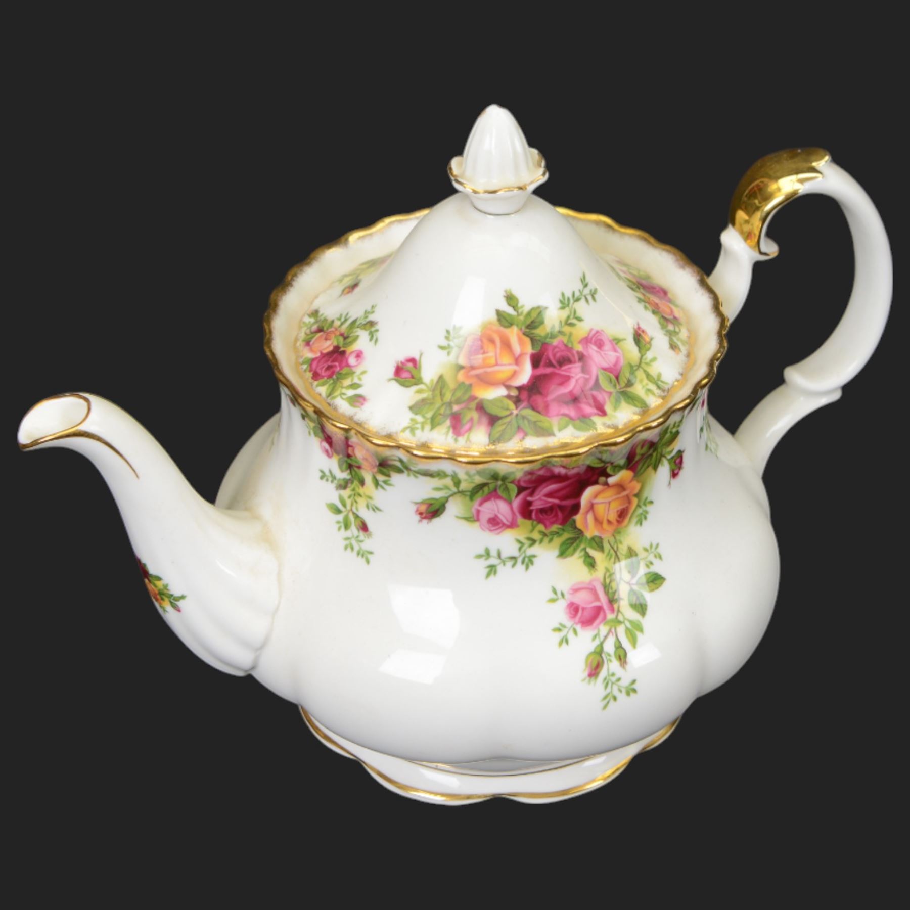 Royal Albert Country Roses tea and dinner service for six place settings, comprising teapot, milk jug, cups and saucers, dessert plates, side plates and dinner plates, all with printed mark beneath 
