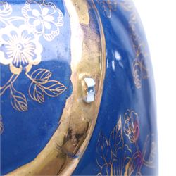 Pair of 20th century foo dog incense burners, decorated with gilt flowers and insects upon a blue ground, on wooden stands, H58cm 