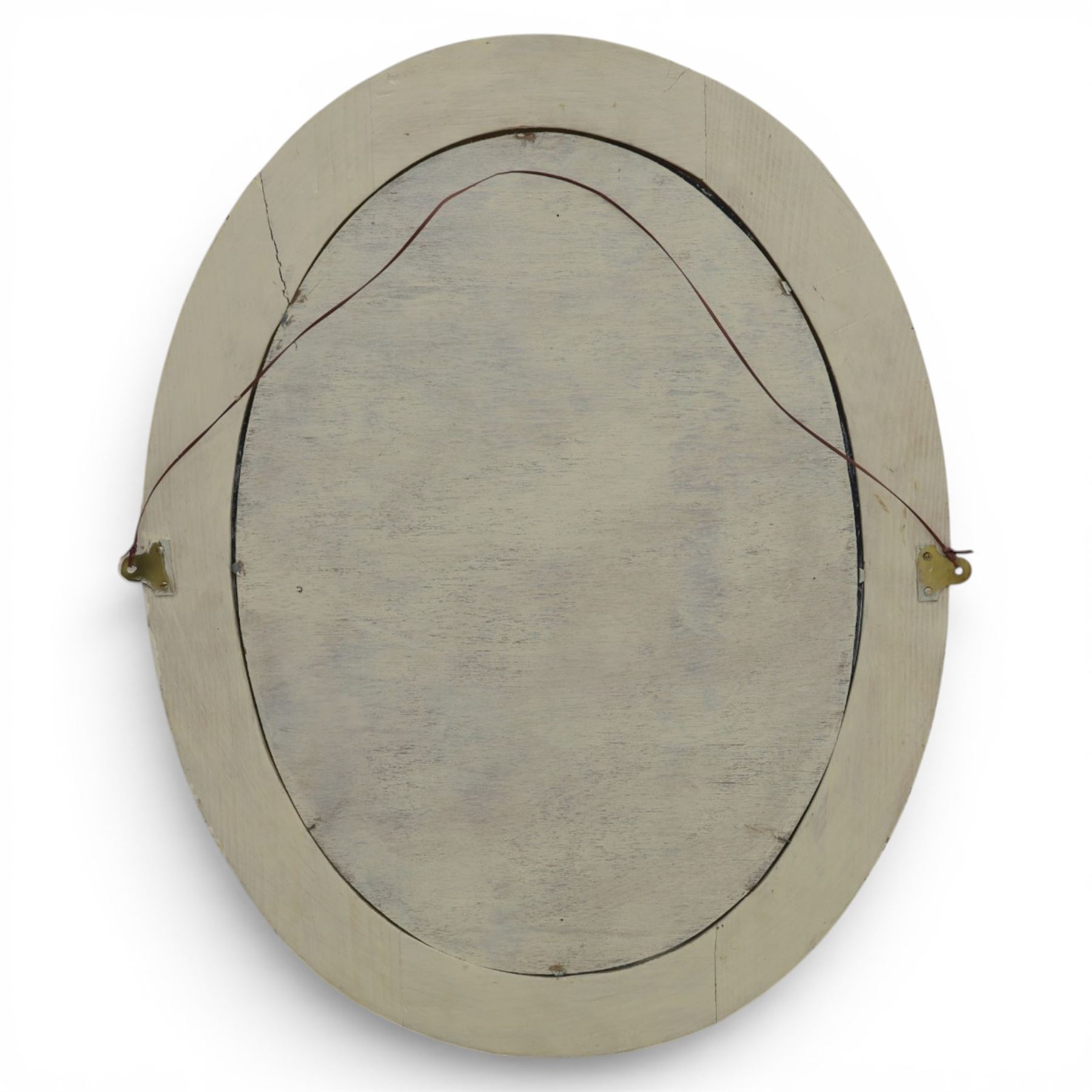 Oval painted pine wall mirror, with carved stepped edge, with mounts for hanging