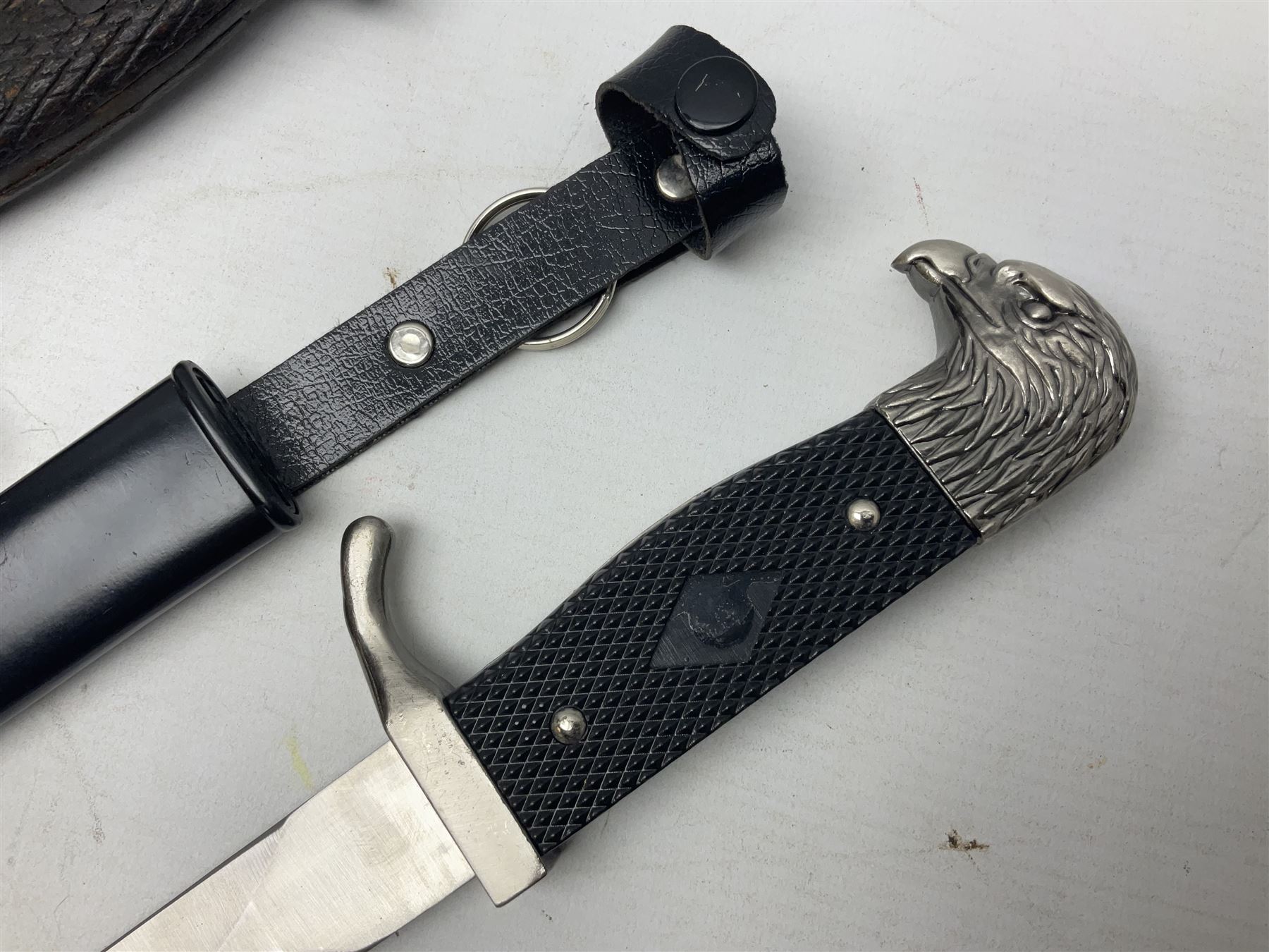 Spanish Model 1941 Bolo bayonet the 24cm steel blade marked 'NF Toledo 4992 H'; in steel scabbard marked '5828 F' L39.5cm overall; Arabian Jambiya type knife with white metal covered grip and jewelled scabbard, inscribed script to blade; and replica WW2 German dagger/knife in scabbard (3)