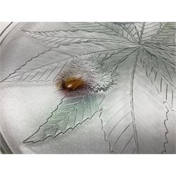 Two French pressed glass bowls of shallow circular form, relief moulded with flowers and foliage, together with a matching charger, largest bowl D34cm  