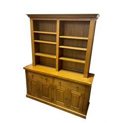 Oak bookcase on sideboard, fitted with six adjustable shelves, lower section with two drawers over two panelled double cupboards, retailed by Alexander Ellis of Beverley