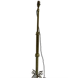 Victorian brass floor standing oil lamp, column decorated with ivy and acanthus leaves, the tripod base pierced with scrolled foliate decoration, with ivory and gilt shade, later converted to electricity