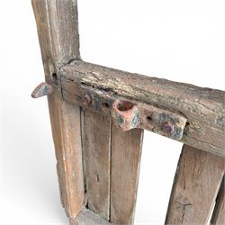 Pair of 19th century weathered wooden ecclesiastical church gates, the cresting rail over four pierced arches with slatted lower section, fitted with heavy cast iron hinges, latch and fittings