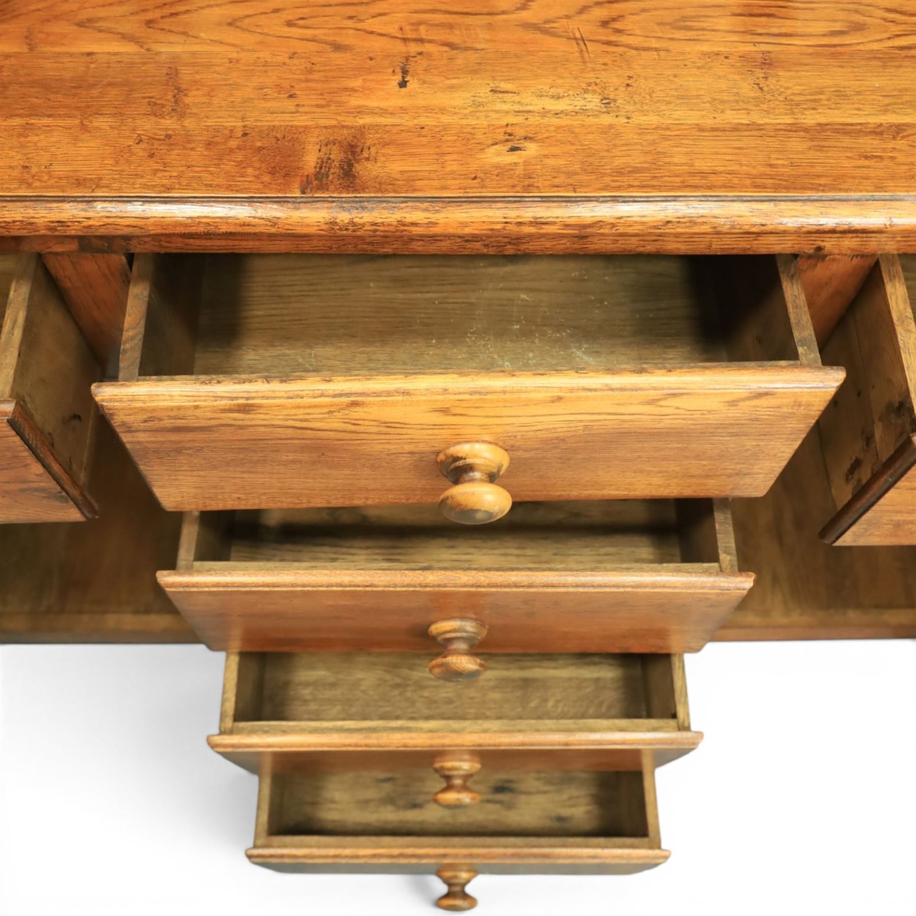 Traditional oak dresser with plate rack in the manner of Titchmarsh & Goodwin, plate rack with projecting cornice and shaped and pierced frieze, tongue and groove back three racks, over seven small spice drawers, the lower section with three short drawers, central bank three of drawers, fielded panelled sides and cupboard doors, raised on stile supports