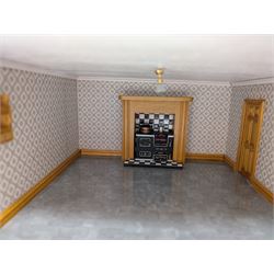 1:24 scale four-storey tudor-style dolls house, with black and white exterior, balcony garden, glazed panelled windows and wooden shingle roof, with decorated interior and wired fireplaces and lighting, H65cm, W58cm, D31cm, 