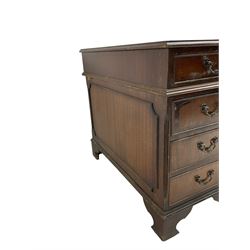 Edwardian mahogany twin pedestal desk, rectangular top with inset leather writing surface, fitted with nine cock-beaded drawers, flanked by reeded canted uprights