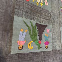 Guatemalan hand stitched wall hanging panel, naively embroidered with figures, animals, and flowers in a bright pallet, upon a dark green ground, approximately H230cm W115cm