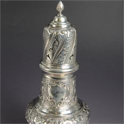 Victorian silver sugar caster, of bellied urn form, embossed with floral and foliate motifs, with two vacant cartouche, upon a domed stepped circular foot, with pierced removable cover with flambe finial, hallmarked Marston & Bayliss, Chester 1900, H25cm