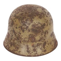 WWII German Third Reich M1940 helmet, with desert camouflage, the left inner brim stamped SE64, the back inner brim stamped 506, with leather eight tongue liner, together with German M34 helmet