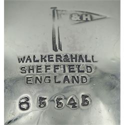 Two early 20th century silver sauce boats, the first example with flying scroll handle, upon three hoot feet, hallmarked Walker & Hall, Sheffield 1916, the second with shaped rim and acanthus capped scroll handle, upon three pad feet, hallmarked Henry Bourne, Birmingham 1903, approximate total silver weight 6.65 ozt (207 grams)