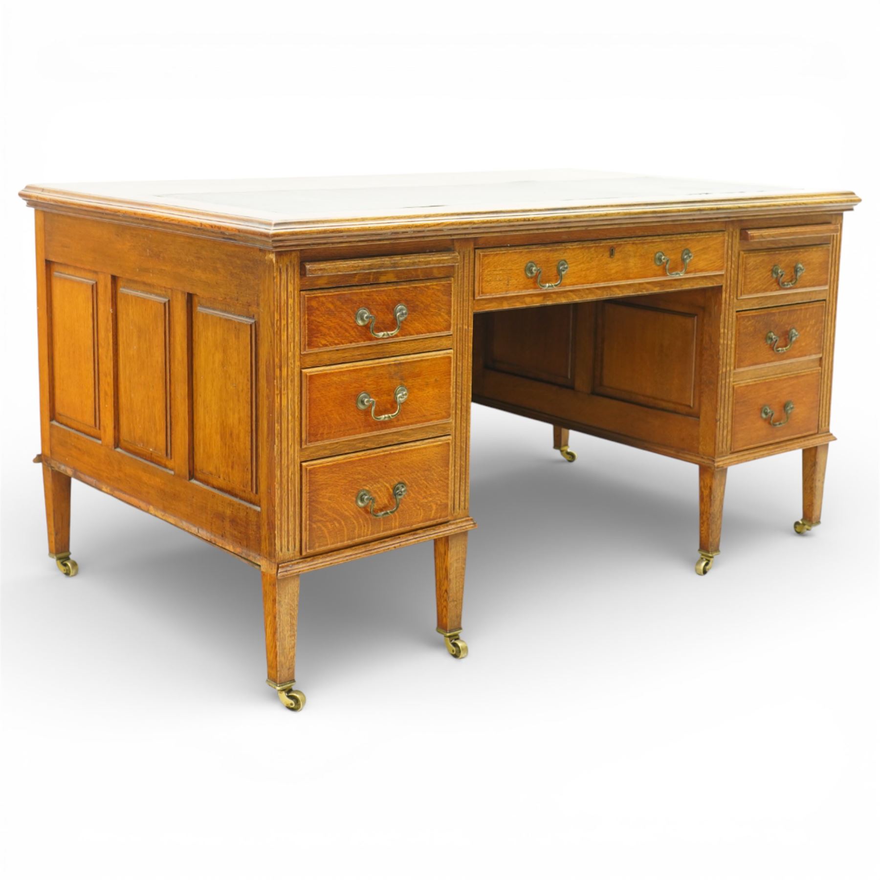 20th century oak kneehole desk, rectangular black leather inset top, above a single frieze drawer, flanked by two pedestals with slides and drawers, panelled sides and back 