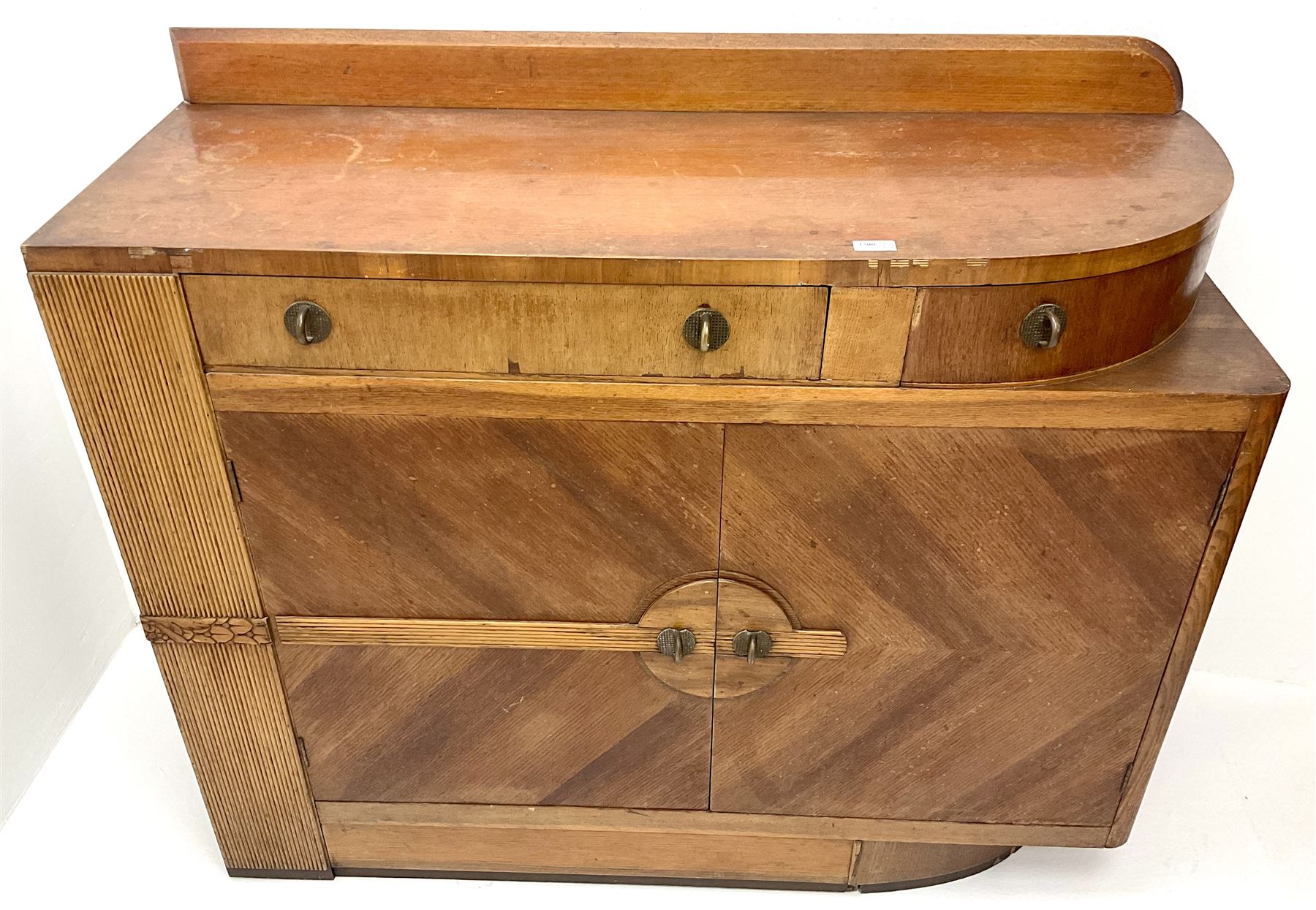 Art Deco oak sideboard, raised shaped back, two drawers above two cupboards, platform base