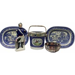Group of 19th century pottery, comprising Copeland Spode slop bucket or pail with raffia wrapped handle, decorated with panels of exotic birds against a blue band, with printed mark beneath, not including handle H27.5cm D28cm, a Staffordshire figure titled Louis Napoleon, two plate and white Willow pattern platters, and a Masons Ironstone bowl, of octagonal form decorated in Imari type pallet, D22cm. 