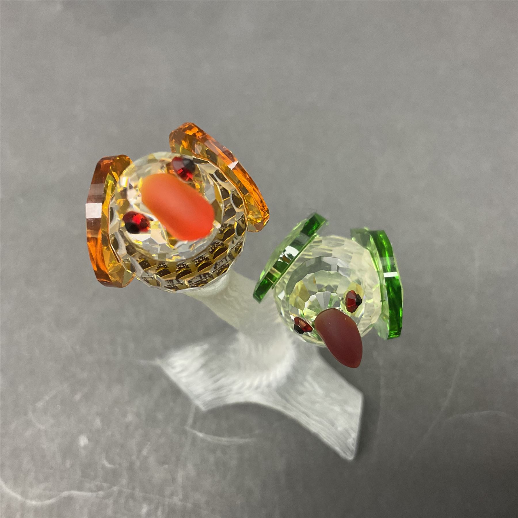 Three Swarovski Crystal bird figures, comprising Toucan, pair of puffins and pair of parrots on a branch, tallest H10cm