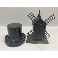 Early 20th century French bronze money bank in the form of a windmill with revolving sails, on oblong base H20cm; and tin-plate 'College' money bank in the form of a top hat by W.M. Livens & Co. Ltd. c1907 L18cm (2)