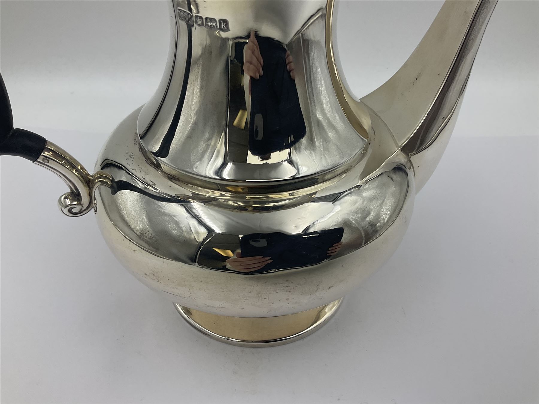 1920s five-piece silver tea service, comprising teapot, coffee pot, hot water pot, twin handled open sucrier and milk jug, each of squat circular form with shaped rim, the teapot, coffee pot and hot water pot each with ebonised handle and finial, the sucrier and milk jug with acanthus capped scroll handles, all upon circular foot, hallmarked R F Mosley & Co, Sheffield 1926 & 1927, tallest H24cm