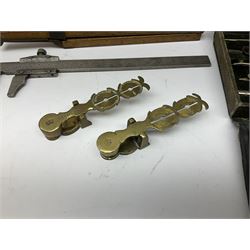 Two Victorian brass sovereign scales, one marked 'Harrison' L10cm; cased set of drawing instruments by G. Thornton Limited Manchester; Chesterman No.770/1 steel vernier caliper; two boxwood rulers; cased slide rule; brass and boxwood rope/wire gauge etc