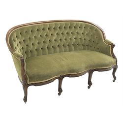 Victorian mahogany framed three seat settee, upholstered in deeply buttoned green fabric, cabriole shaped supports, brass castors