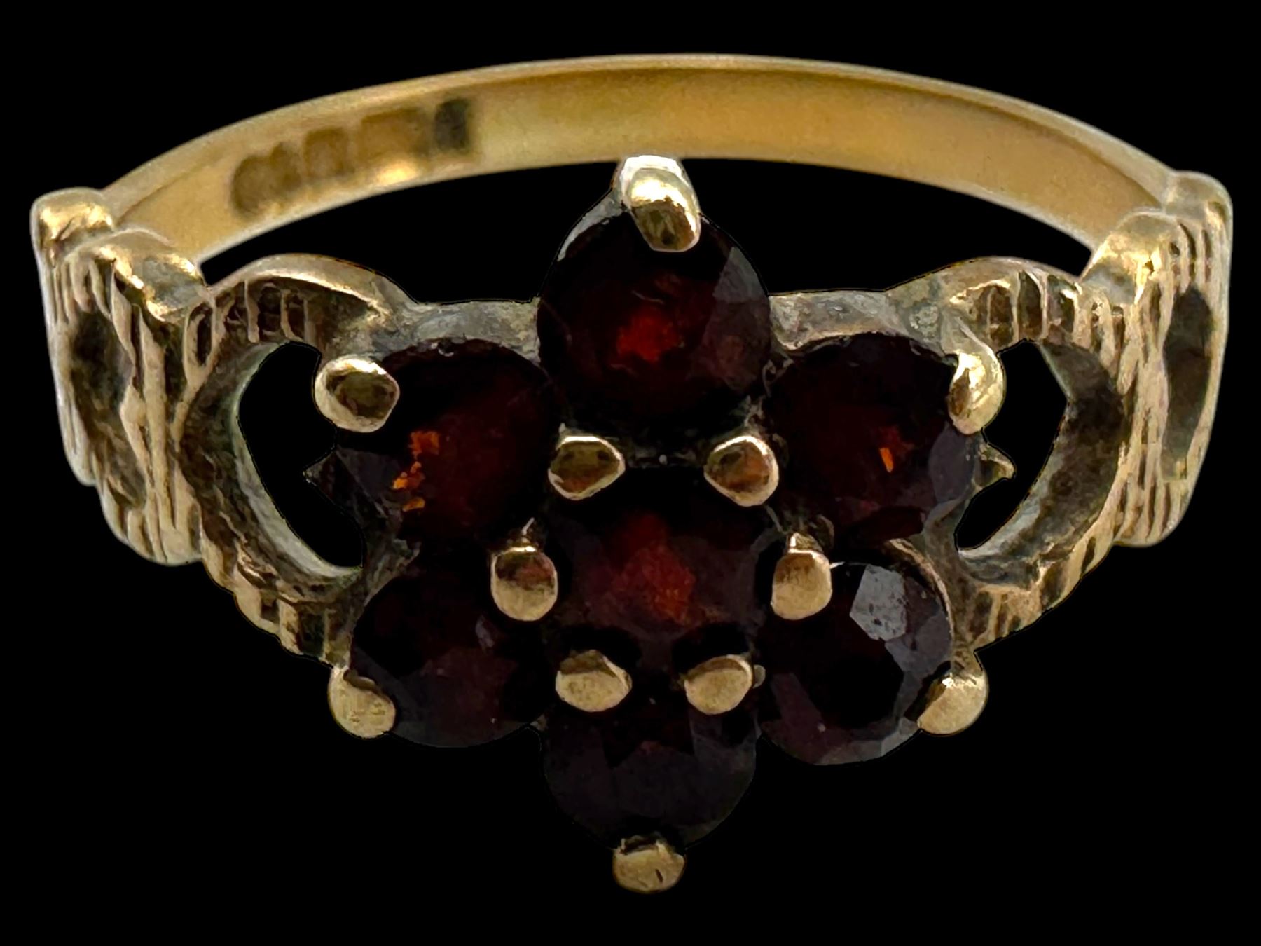 Four 9ct gold stone set rings, including garnet and pearl examples, all stamped or hallmarked