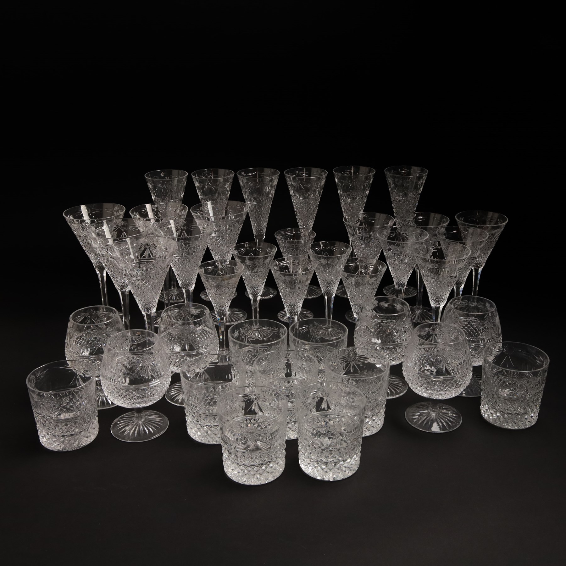  Suite of Stuart crystal Beaconsfield pattern table glass, comprising 6 claret glasses, 6 white wine glasses, 6 dessert wine glasses, 6 brandy balloons, 6 champagne flutes, and 9 whisky glasses