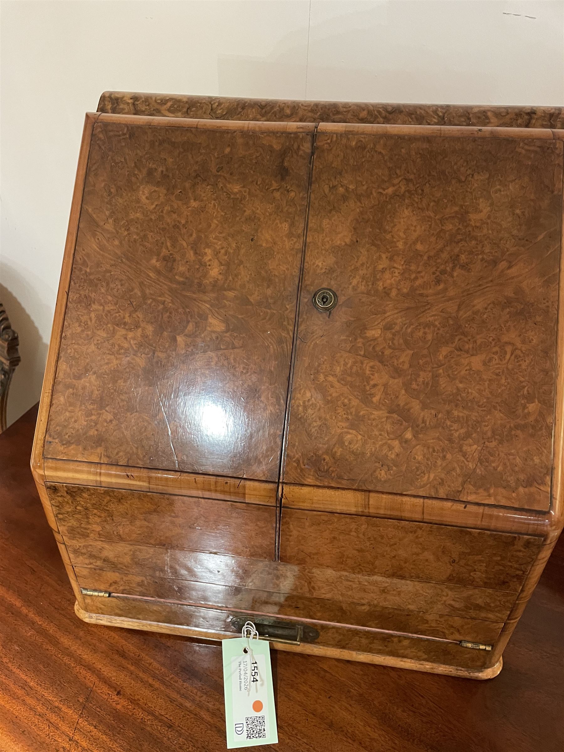 19th century burr walnut correspondence box, the sloped front opening to reveal a fitted interior with perpetual calendar, letter racks, and pen tray between two inkwell recesses, above a pull out draw with recessed brass handle, H41cm L40.5cm D28.5cm