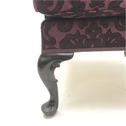 Traditional Queen Anne style high wingback armchair upholstered in purple fabric with raised scrolling pattern, on cabriole feet