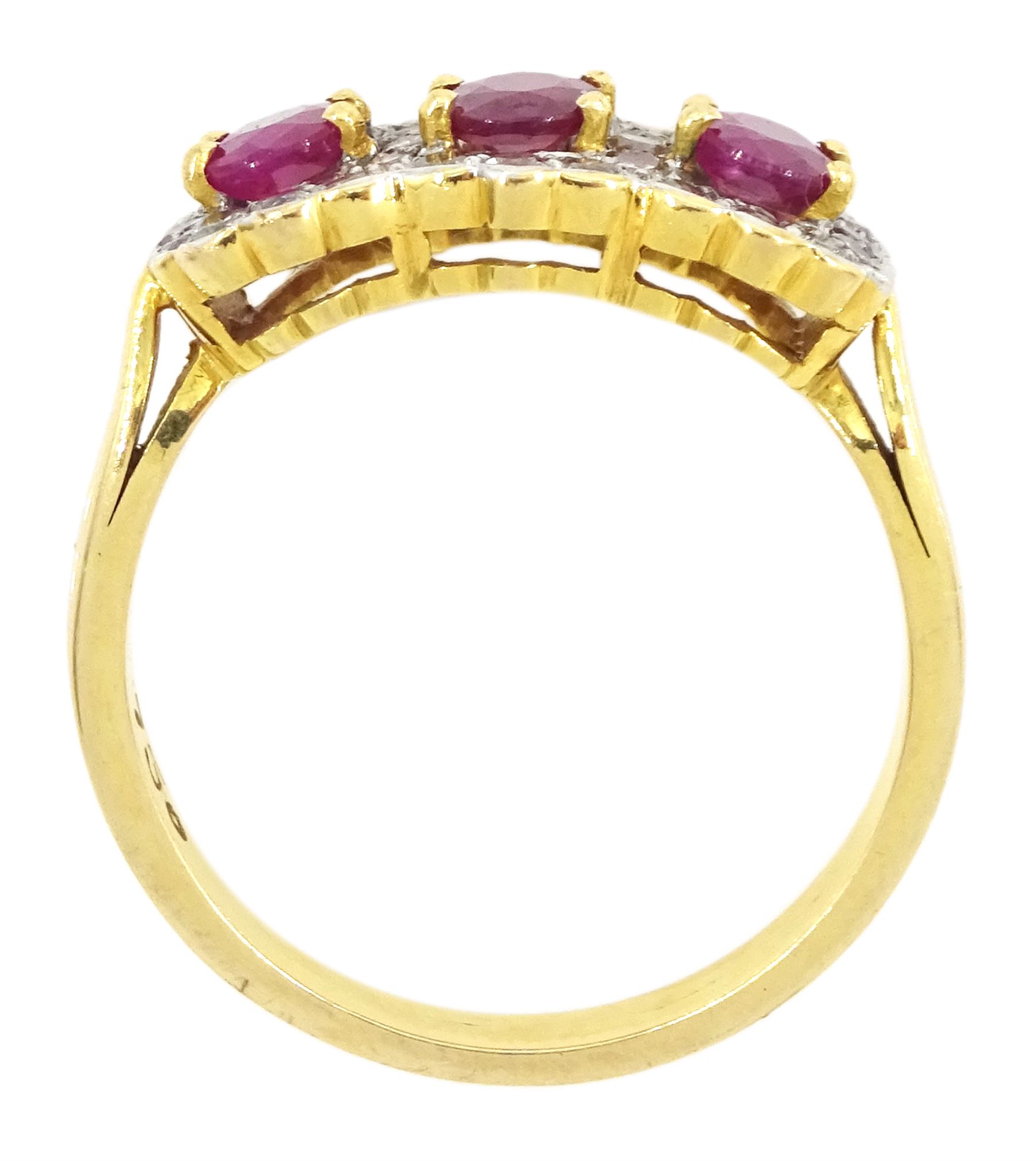 18ct gold three stone oval cut ruby and diamond cluster ring, stamped 750
