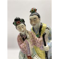 Oriental ceramic figure modeled as a woman reading with a man stood behind her, with stamped mark beneath H39cm.  