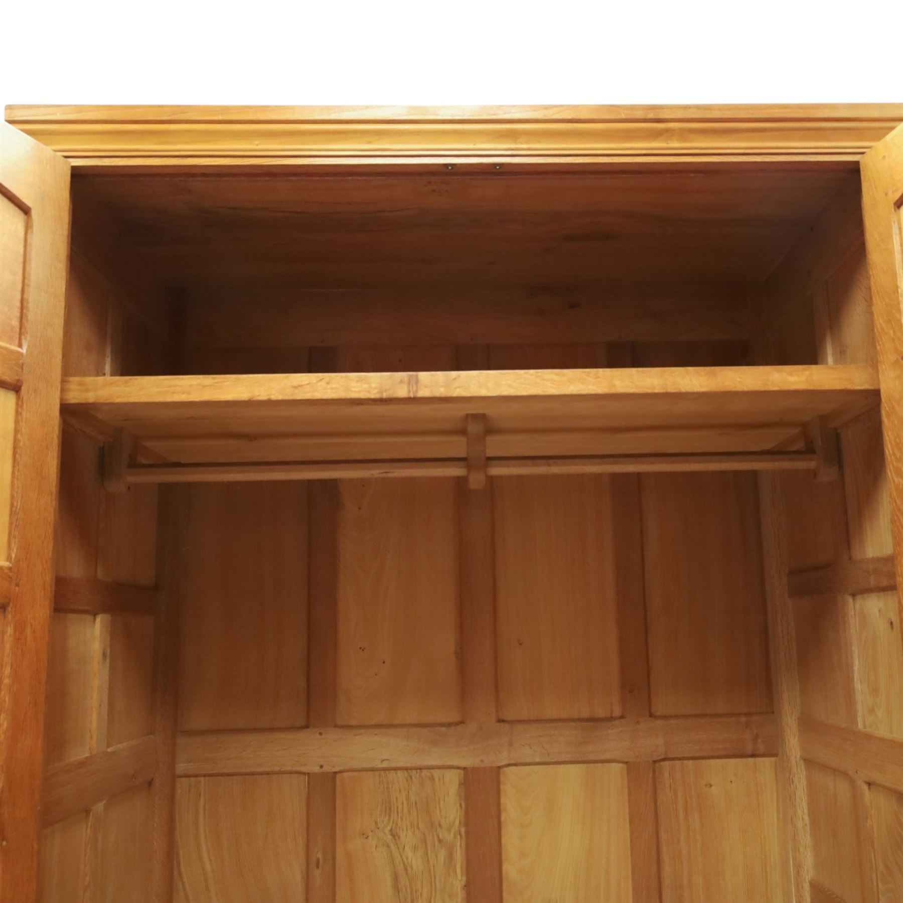 Beaverman - oak double wardrobe, enclosed by twin multi-panelled doors, Yorkshire Rose carved handles, the interior fitted with shelf and hanging rail, with signature carved beaver, by Colin Almack of Sutton, near Thirsk