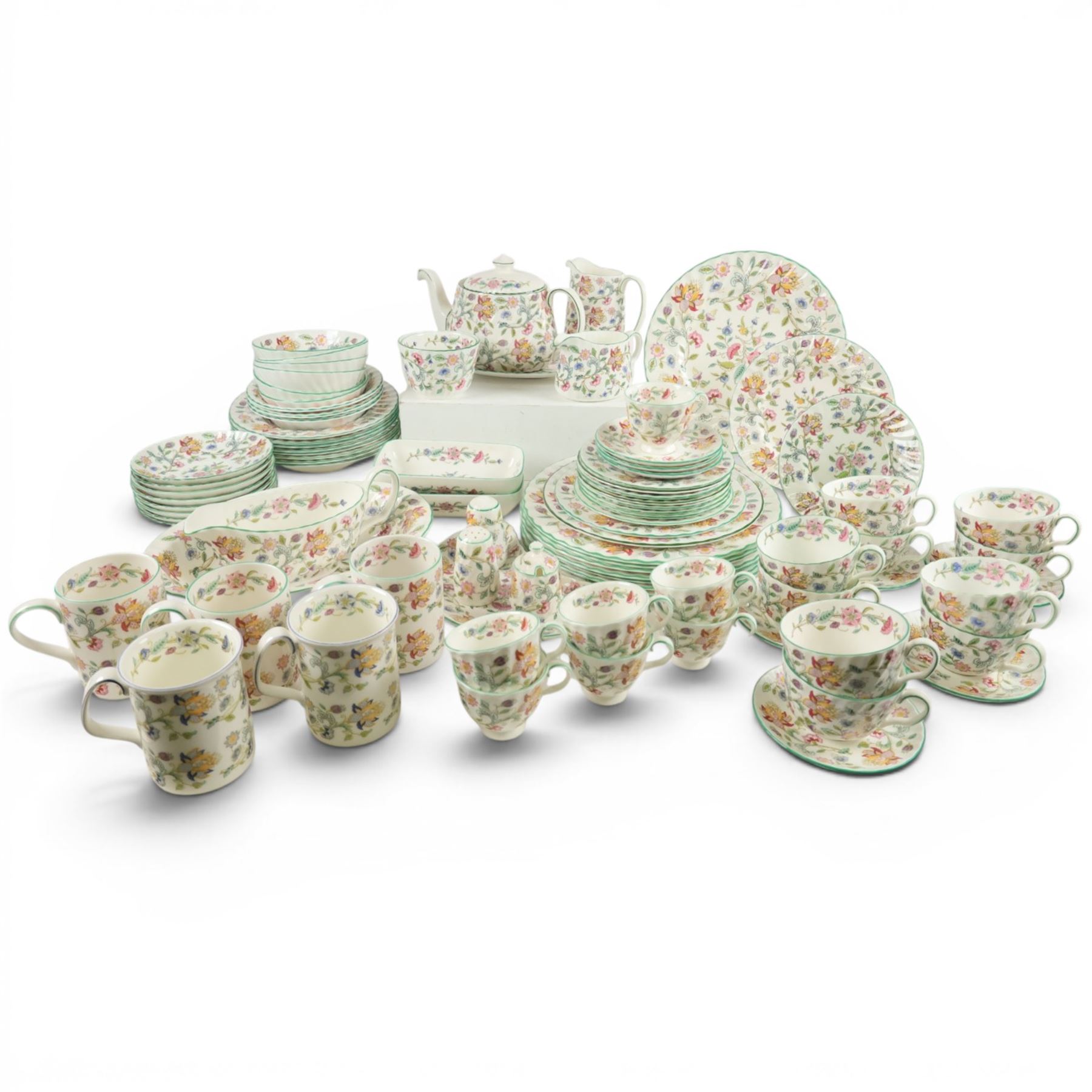 Minton Haddon Hall tea and dinner service, including teapot, milk jug, hot water jug, open sucrier, ten teacups and eight saucers, eight dinner plates, eight soup bowls, etc 
