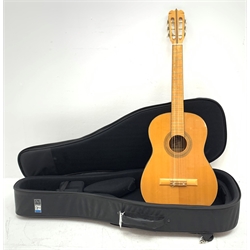 A Hondo guitar, with a 'Protection Racket' classcal 7052 case.