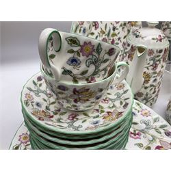 Minton Haddon Hall pattern tea and dinner wares, including basket dish, two covered tureens, six dinner plates, eight dessert plates, twelve tea plates, six soup bowls, six cereal bowls, teapot, coffee pot, milk jug, covered sucrier twelve tea cups and saucers, six mugs, footed bon bon dish, pair of candlestick holders, cake knife and slice etc (81)