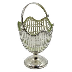  Silver pedestal swing handle sugar basket, pierced decoration and glass liner by George Nathan & Ridley Hayes, Chester 1912, H12cm. Provenance Property of Bob Heath, Brandesburton Formerly of Ravenfield Hall Farm near Rotherham  
