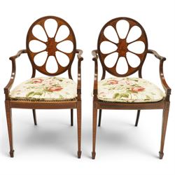 Hampton & Sons (Pall Mall 1830-1957) - Pair of Edwardian inlaid mahogany wheel-back elbow chairs, the pierced oval backs with chequered stringing and cross banding, out-swept arms over canework seats, banded seat rail over square tapering supports with spade feet, stamped to underside
Provenance: Kirkham Hall