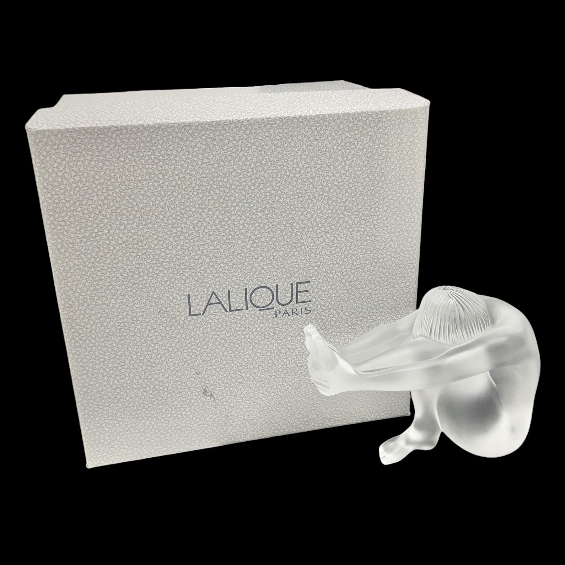Lalique Nude Temptation, a frosted glass figure of a woman crouching with leg outstretched, in original box, H8cm