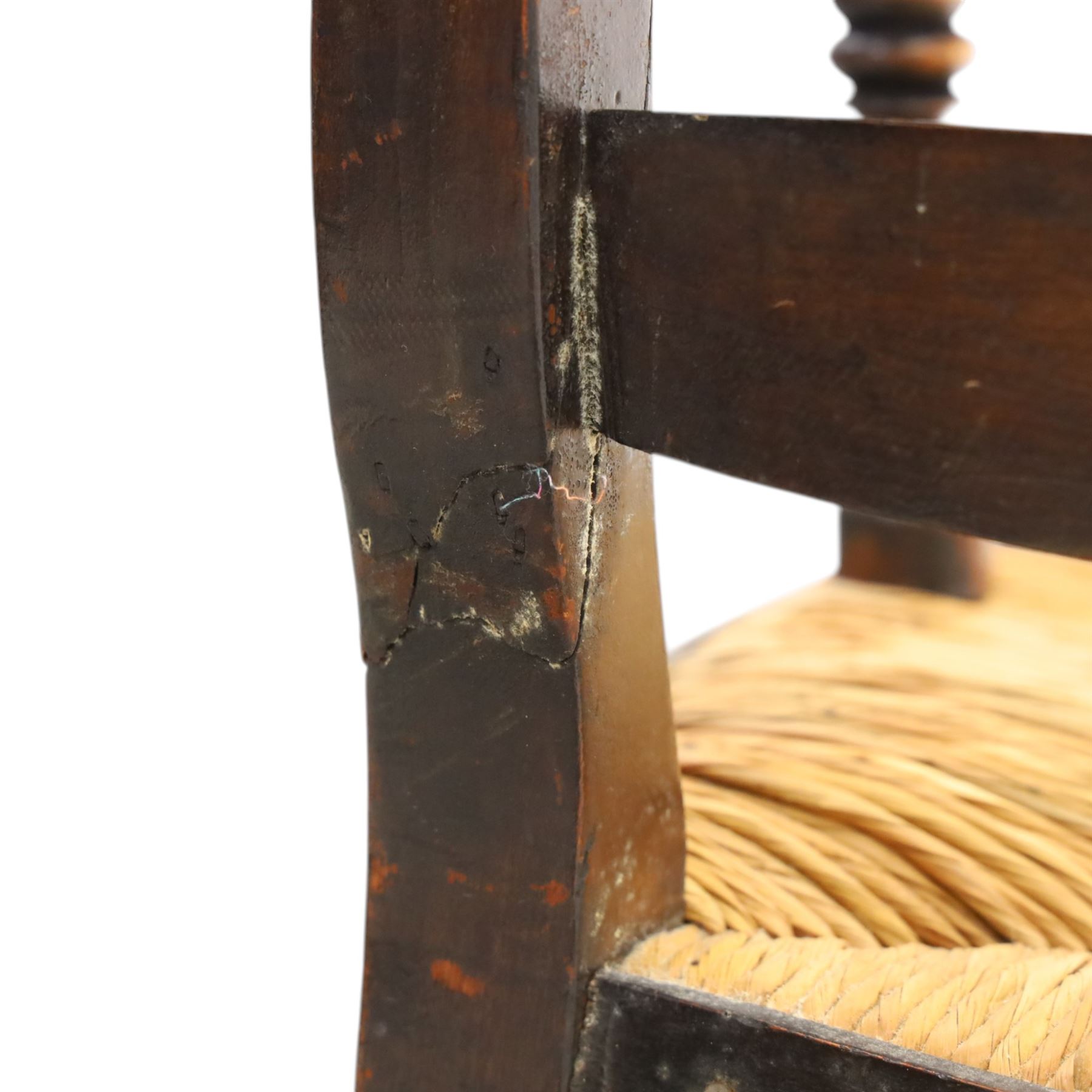 19th century elm chair, with curved top rail and bobbin turned spindles, woven rush seat, on turned legs united by front stretcher