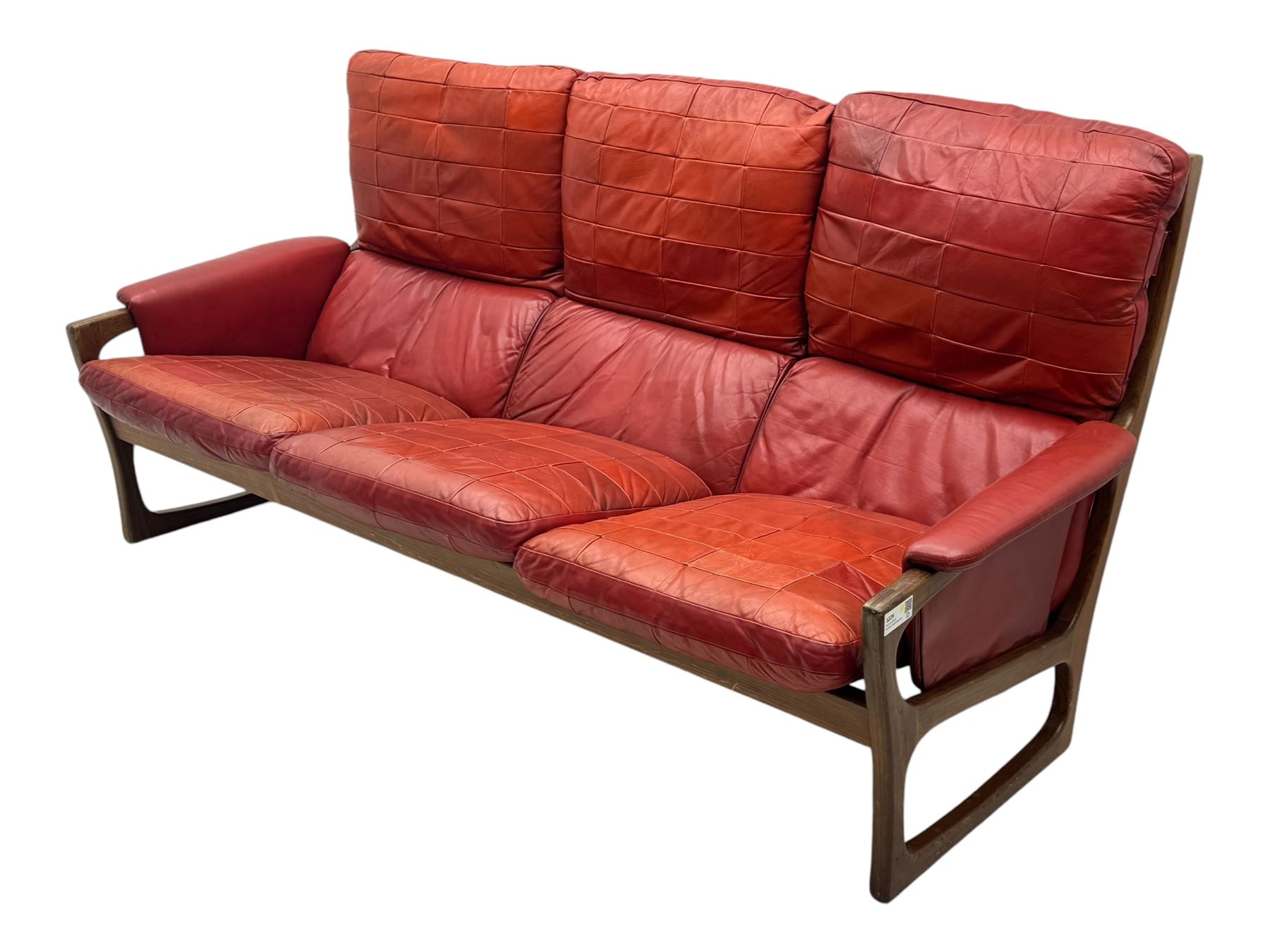 Folke Ohlsson for Gimson & Slater - mid-20th century Danish teak-framed sofa, red leather upholstery with patchwork design, raised on shaped teak side supports