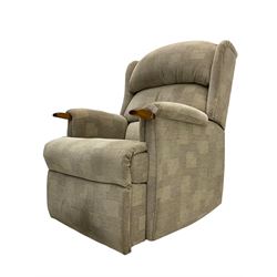 Reclining armchair upholstered in cream fabric