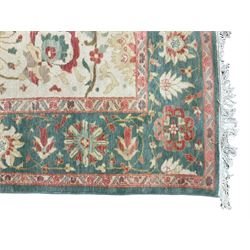 Persian Ziegler design carpet, pale ground field decorated with large stylised plant motifs, the border decorated with large floral motifs within repeating guards